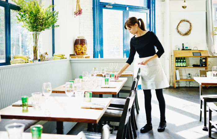 Waitresssettingtablesinemptyrestaurant