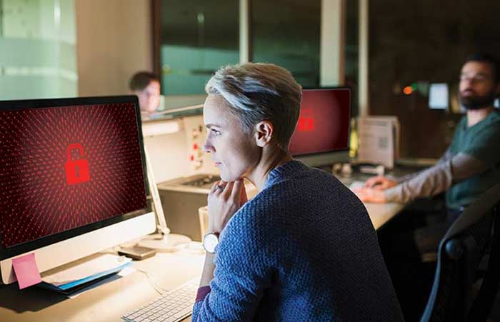 Woman Working Late Ransomware on Computers