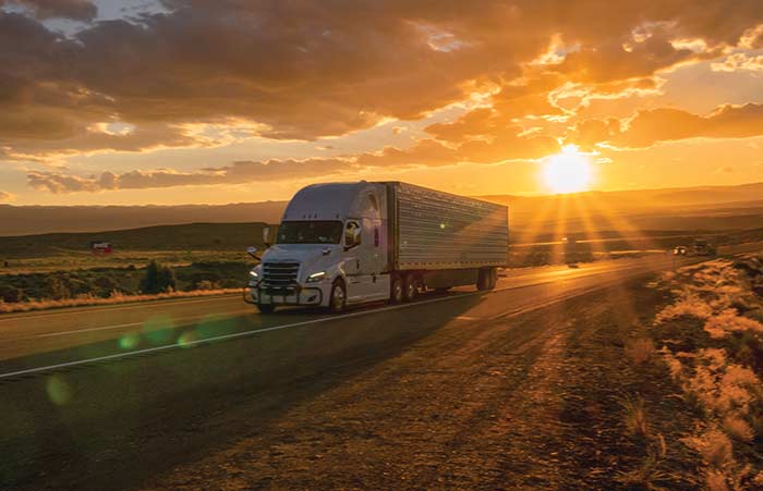 Semi Heading East Sunrise in Back
