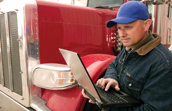 Trucker Driver Looking at Laptop