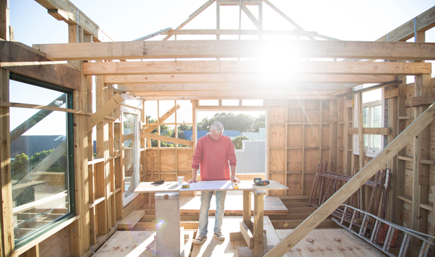 Builder working on a wood framed house