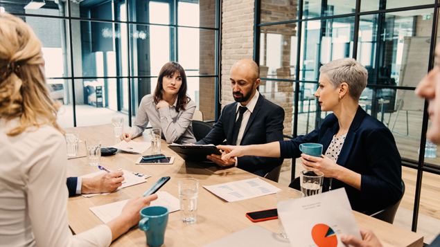 Conference Room Group Reviewing Financials