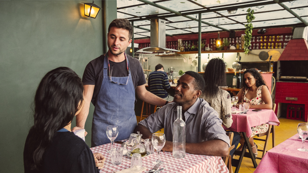 Restaurant Owner Talking with Customers
