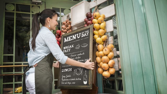 Restaurant Working Placing Menu Outside