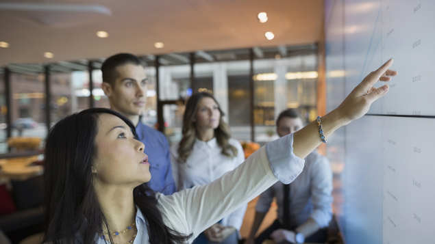 Business Woman Pointing at Screen