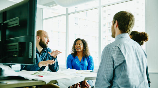 Businessman Leading Discussion During Meeting