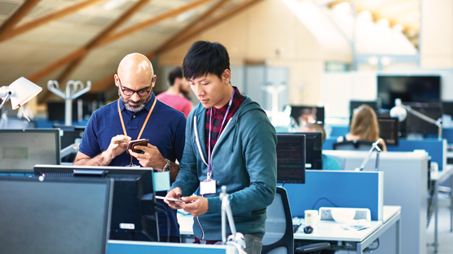 IT Professionals Working on Phones and Computers