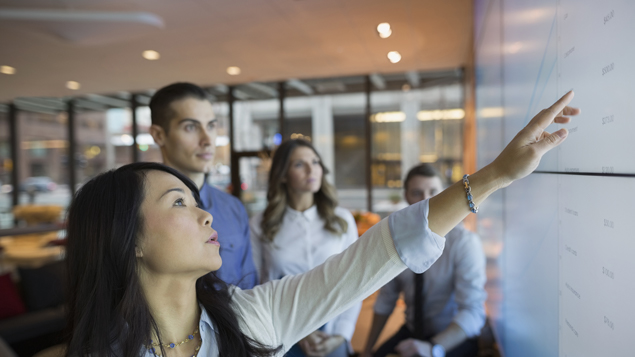 Business Woman Pointing at Screen