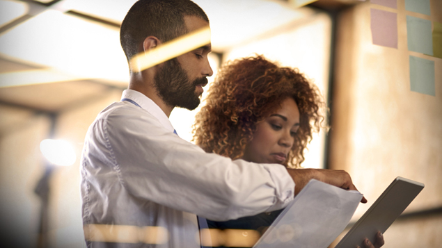Businessman Buisnesswoman Reviewing Paperwork