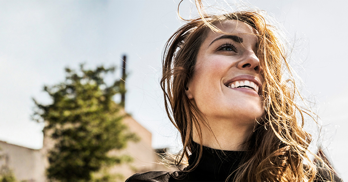 Portrait of happy woman with blowing hair