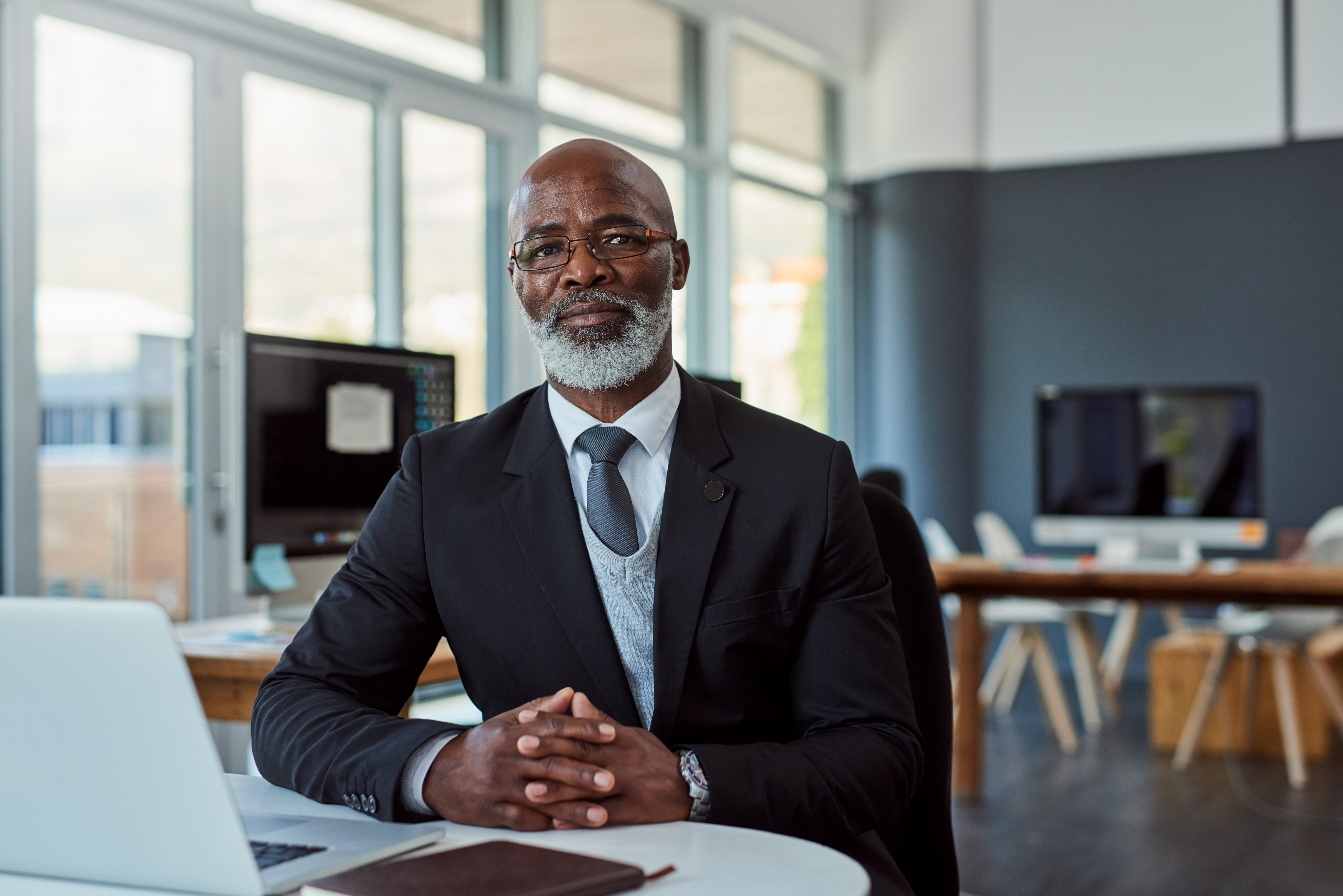 Man sitting at desk pondering
