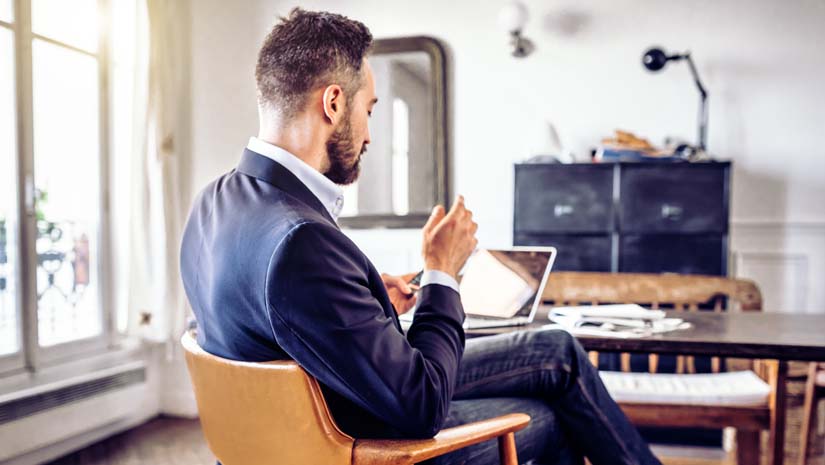 Bearded Businessman Looking at Mobile in Home Office