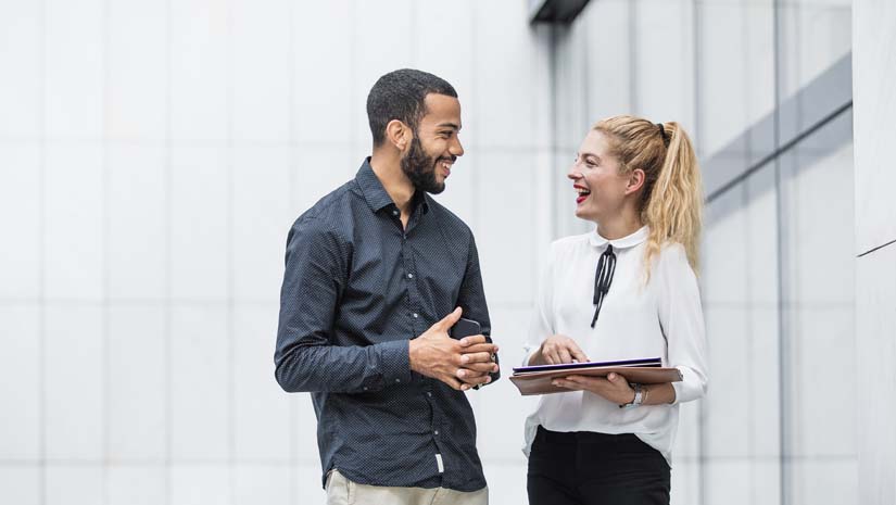 Business people discussing in front of building