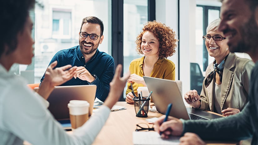 Business people sitting around the table and talking