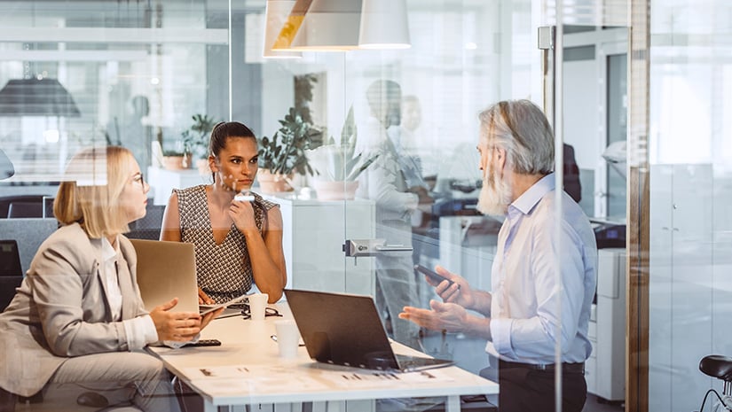 Business People sitting at desk discussing