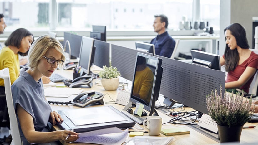 Business people working at desk by windows