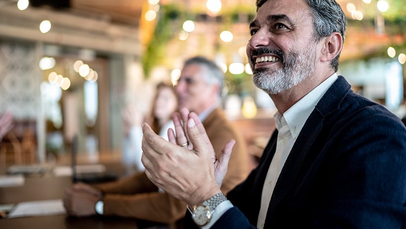 Businessman applauding at business meeting