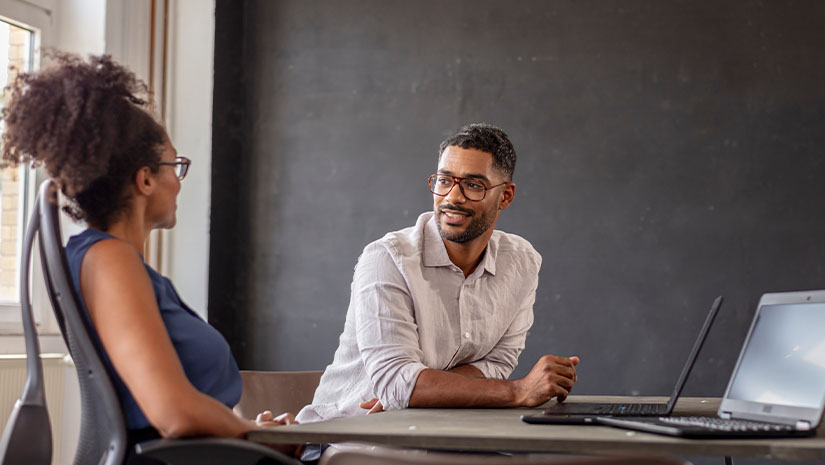 businessman looking at female manager in her modern office