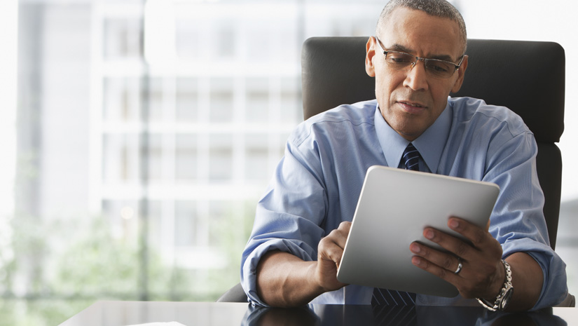 Businessman looking over electronic tablet