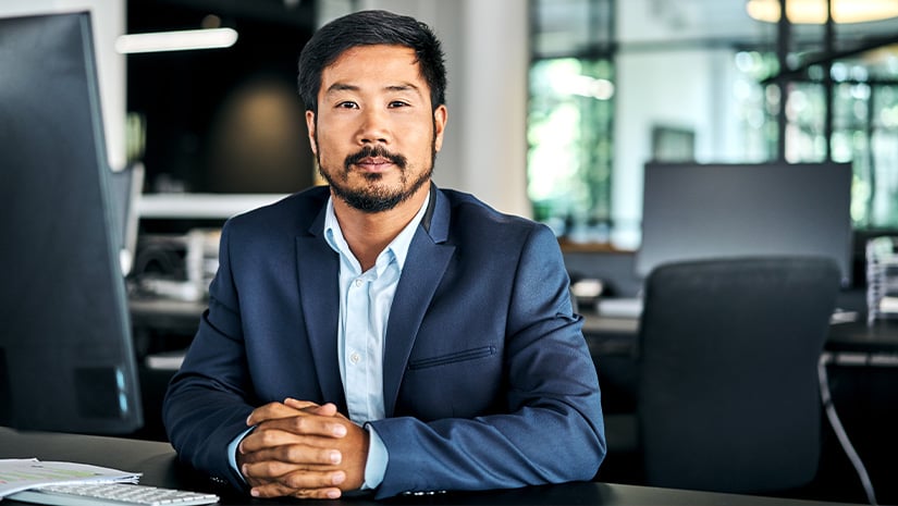 Businessman sitting with hands clasped