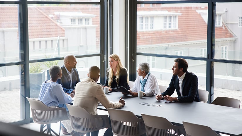 Businesspeople talking together during a meeting in an office boardroom