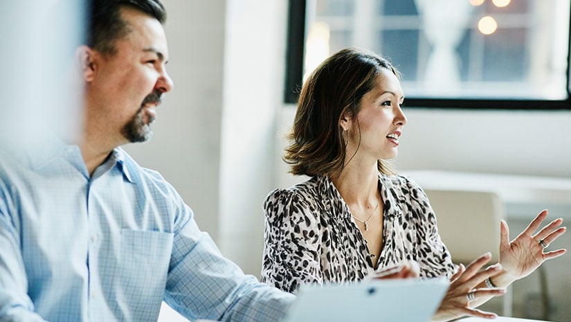 Businesswoman leading team meeting in coworking office