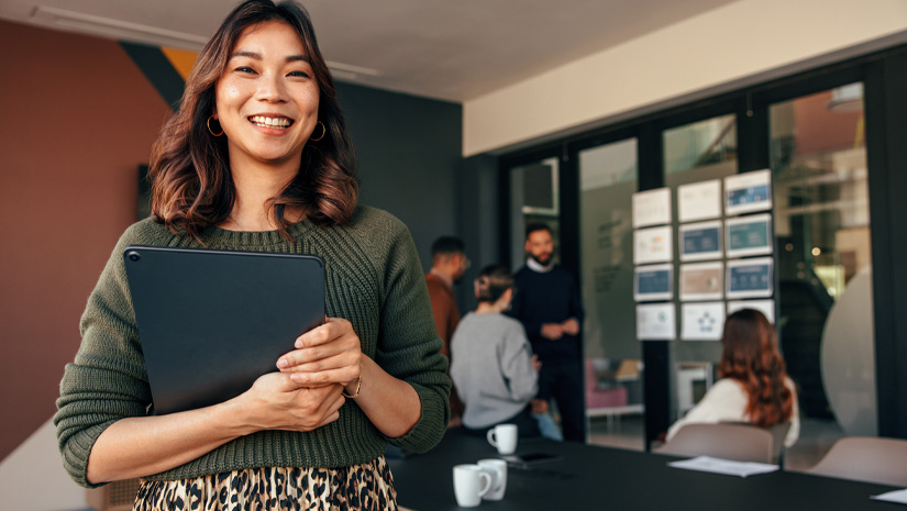 Cheerful Businesswoman Smiling at Camera in Boardroom