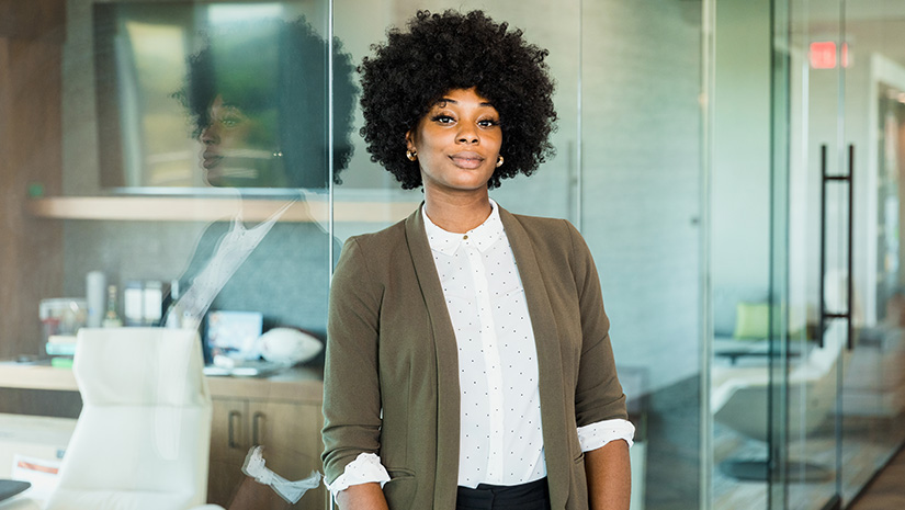 Confident female lawyer stands outside office