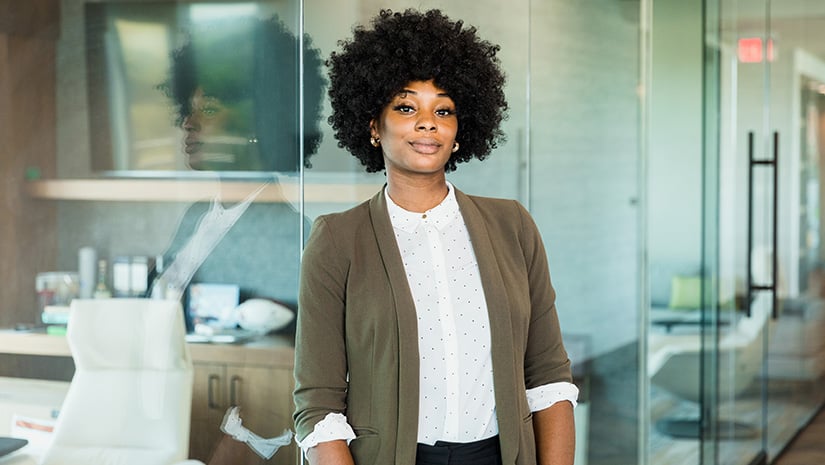 Confident female lawyer stands outside office