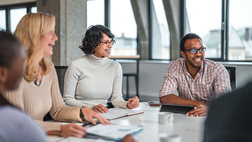 Coworkers smiling at business meeting