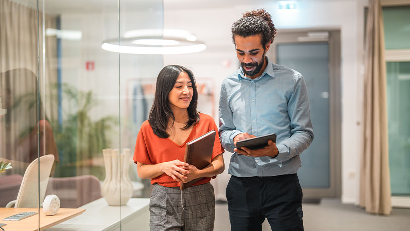 Diverse colleagues working on a tablet