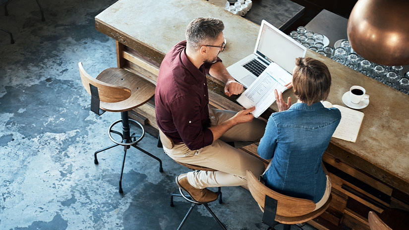 Two colleagues working together at local coffee shop