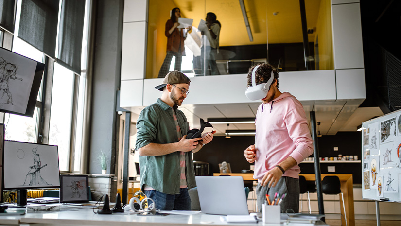 Group of coworkers testing VR simulator in the office