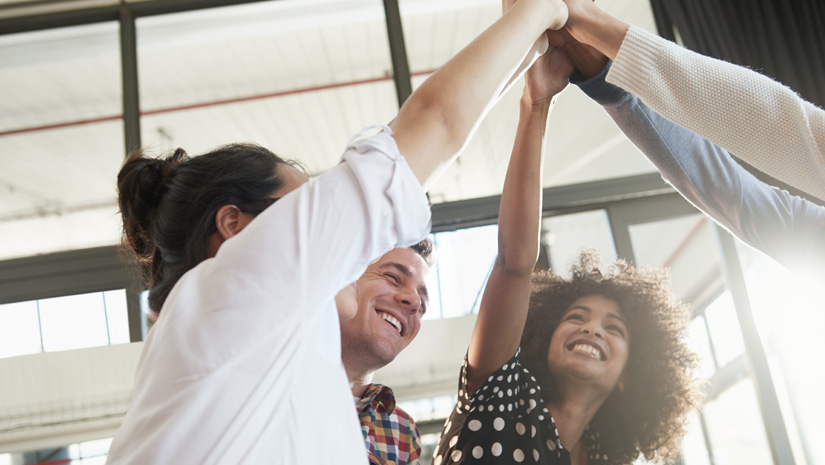 Shot of a group of young business colleagues high fiving each other