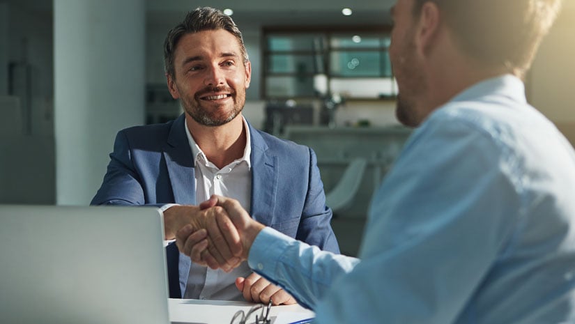 Shot of two businessmen shaking hands in an office