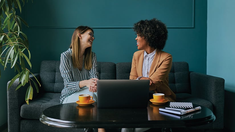 Two businesswomen doing business in a coffee shop