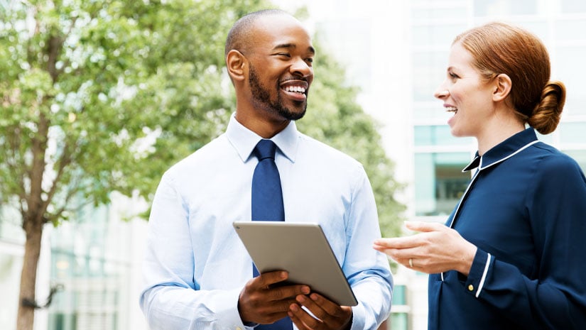 Two people with tablet in financial district