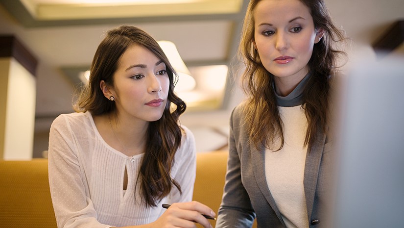 Two Women Working on Project