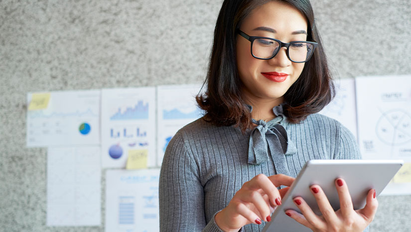 Woman using modern gadgets in work