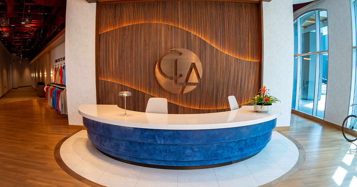 CLA Connection Center Arizona welcome center and desk with large CLA logo behind desk