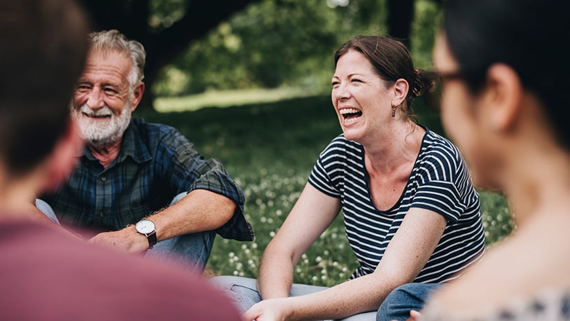 Cheerful woman in the park with her friends