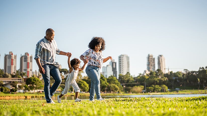 Family strolling in the late afternoon in the city park