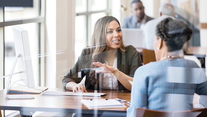 Banker discusses banking services to new customer