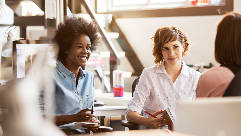 Colleagues talking at informal meeting.