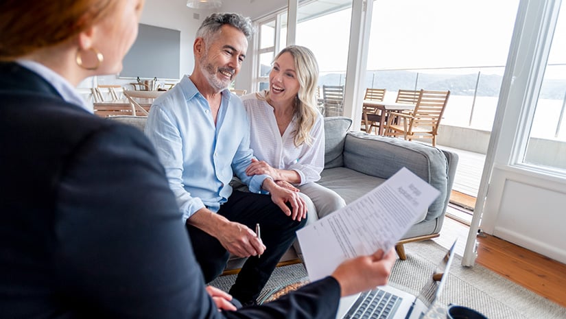 Happy mature couple meeting investments and financial advisor at home