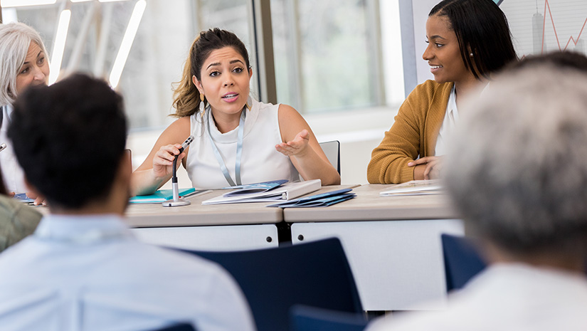 Hispanic panelist answers audience question with empathy