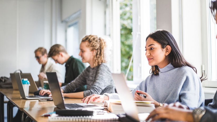 College students studying on laptops