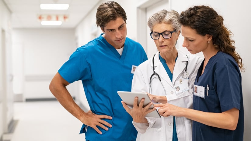Doctor and nurse discussing patient case at hospital