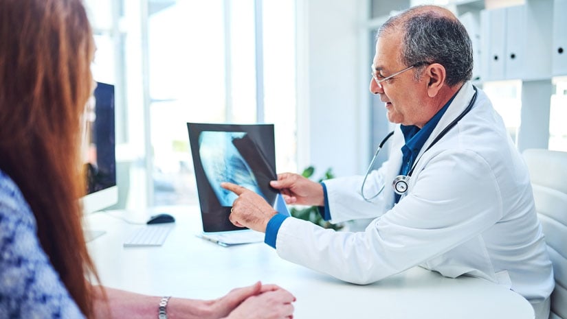 Shot of a doctor discussing an x-ray scan with his patient.