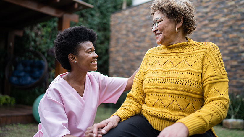 Nurse supporting senior patient walking or moving up the stairs at home Nurse with senior patient doing exercise at home